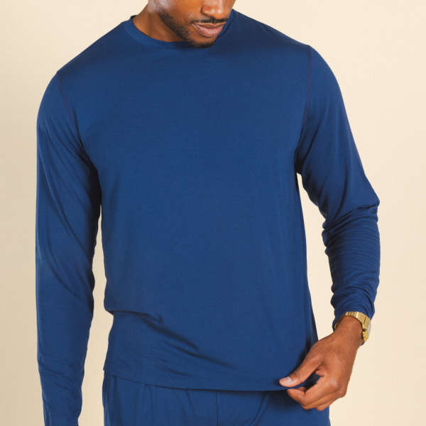 Man in a royal blue long-sleeve Shinesty pajama shirt, gold watch at the cuff