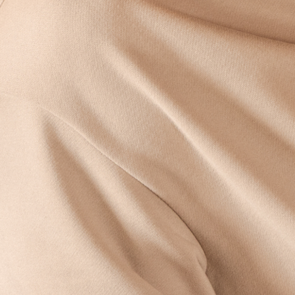 Sueded oatmeal French terry curving across the frame, the fabric of the Shinesty men's sweatshirt