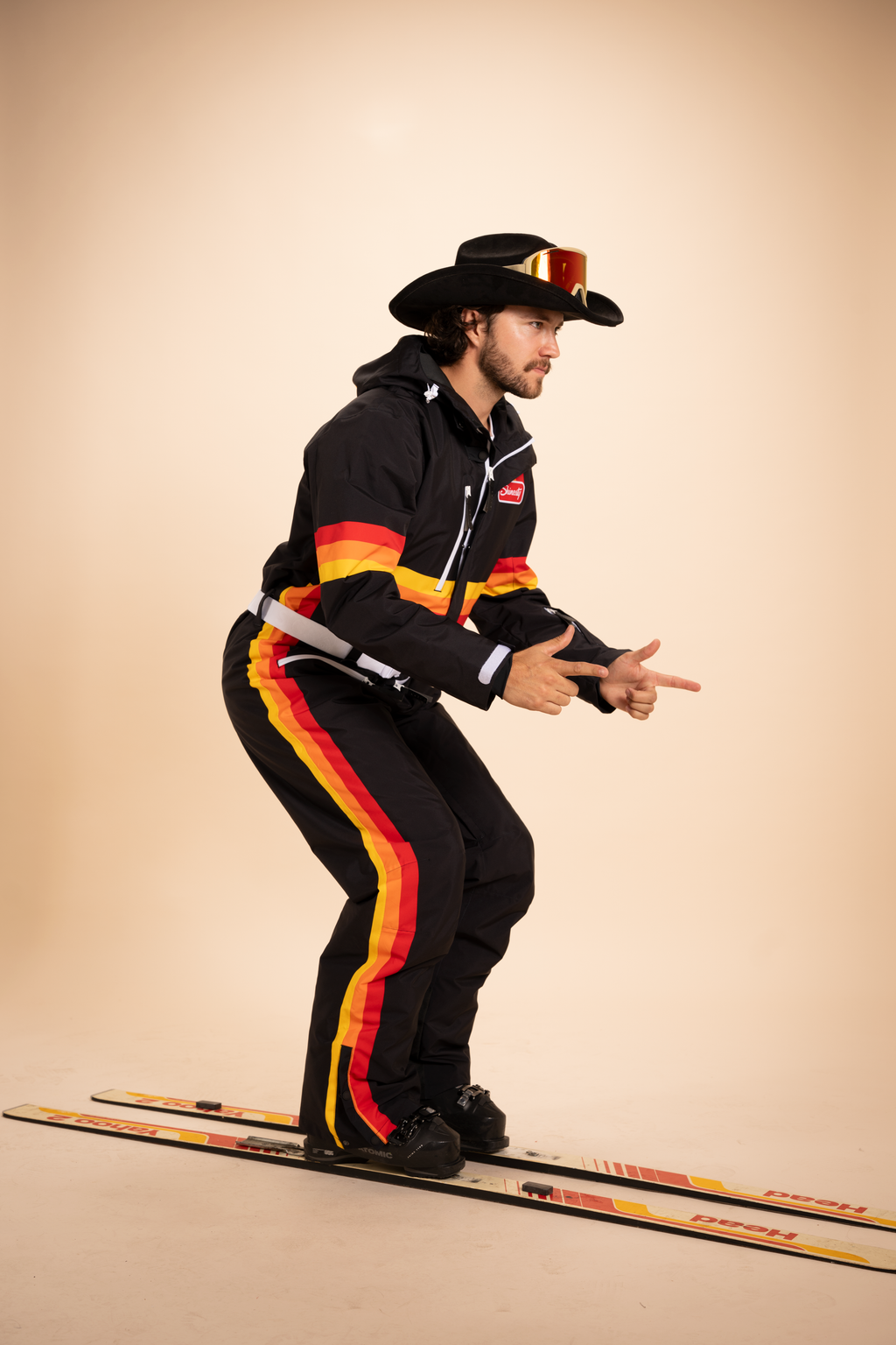 The T-Bar Trooper | Black and Orange Retro Stripe One Piece Ski Suit - Shinesty