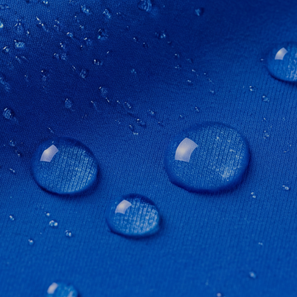 Beads of water scattered over royal blue Shinesty cooling fabric, each one holding its shape on the knit