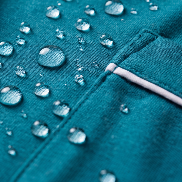 Teal MicroModal pajama fabric holding rows of water beads along a piped edge