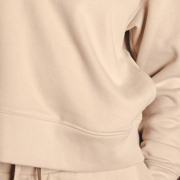 Oatmeal French terry sweatshirt fabric with ribbed hem, hand tucked in the pocket